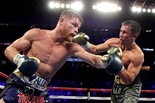 Gennady Golovkin (R) exchanges blows with Canelo Alvarez (L) during their WBC, WBA and IBF middleweight championship fight at the T-Mobile Arena on September 16, 2017 in Las Vegas, Nevada. 
Gennady Golovkin retained his three world middleweight titles, fighting to a draw with Mexican star Canelo Alvarez in a showdown for middleweight supremacy that lived up the hype.
 / AFP PHOTO / John GURZINSKI        (Photo credit should read JOHN GURZINSKI/AFP/Getty Images)