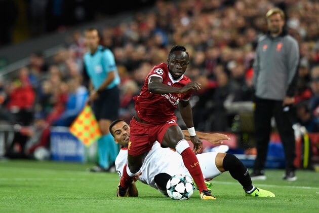 LIVERPOOL, ENGLAND - SEPTEMBER 13: Gabriel Mercado of Sevilla tackles Sadio Mane of Liverpool during the UEFA Champions League group E match between Liverpool FC and Sevilla FC at Anfield on September 13, 2017 in Liverpool, United Kingdom.  (Photo by Stu Forster/Getty Images)