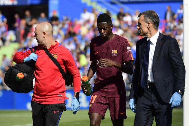 Barcelona's forward from France Ousmane Dembele (C) walks with the team's doctor during the Spanish league football match Getafe CF vs FC Barcelona at the Col. Alfonso Perez stadium in Getafe on September 16, 2017. / AFP PHOTO / PIERRE-PHILIPPE MARCOU        (Photo credit should read PIERRE-PHILIPPE MARCOU/AFP/Getty Images)