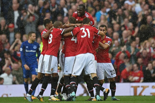 Manchester United's Ecuadorian midfielder Antonio Valencia celebrates with teammates after scoring the opening goal of the English Premier League football match between Manchester United and Everton at Old Trafford in Manchester, north west England, on September 17, 2017. / AFP PHOTO / Oli SCARFF / RESTRICTED TO EDITORIAL USE. No use with unauthorized audio, video, data, fixture lists, club/league logos or 'live' services. Online in-match use limited to 75 images, no video emulation. No use in betting, games or single club/league/player publications.  /         (Photo credit should read OLI SCARFF/AFP/Getty Images)