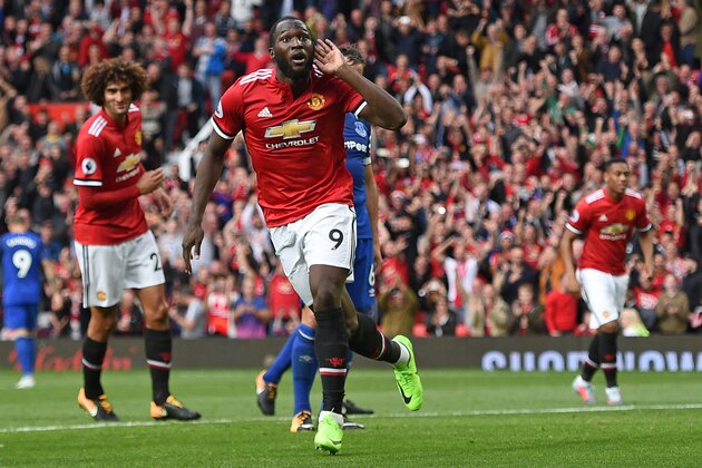 Manchester United's Belgian striker Romelu Lukaku (C) celebrates after scoring their third goal during the English Premier League football match between Manchester United and Everton at Old Trafford in Manchester, north west England, on September 17, 2017. / AFP PHOTO / Oli SCARFF / RESTRICTED TO EDITORIAL USE. No use with unauthorized audio, video, data, fixture lists, club/league logos or 'live' services. Online in-match use limited to 75 images, no video emulation. No use in betting, games or single club/league/player publications.  /         (Photo credit should read OLI SCARFF/AFP/Getty Images)