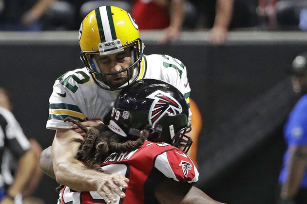 Atlanta Falcons defensive end Adrian Clayborn (99) runs into Green Bay Packers quarterback Aaron Rodgers (12) during the second of an NFL football game, Sunday, Sept. 17, 2017, in Atlanta. The Falcons won 34-23. (AP Photo/David Goldman)