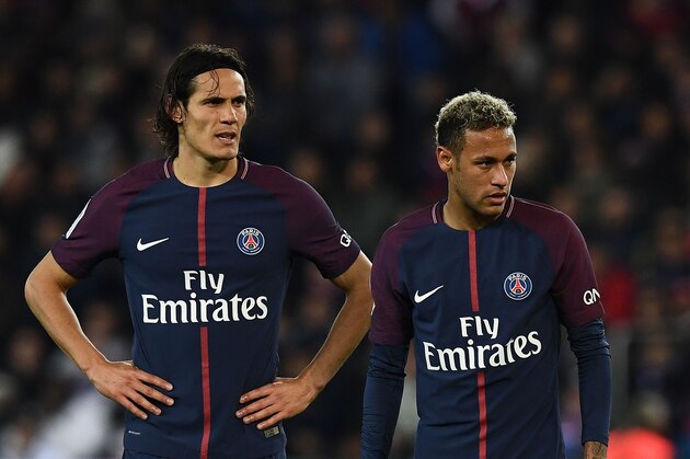 Paris Saint-Germain's Uruguayan forward Edinson Cavani (L) and Paris Saint-Germain's Brazilian forward Neymar react during the French Ligue 1 football match between Paris Saint-Germain (PSG) and Lyon (OL) on September 17, 2017 at the Parc des Princes stadium in Paris.  / AFP PHOTO / FRANCK FIFE        (Photo credit should read FRANCK FIFE/AFP/Getty Images)
