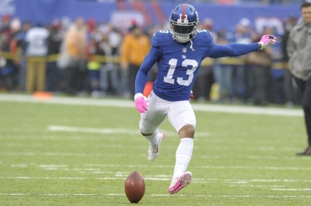 New York Giants wide receiver Odell Beckham kicks a football before an NFL football game against the Detroit Lions Sunday, Dec. 18, 2016, in East Rutherford, N.J.  (AP Photo/Bill Kostroun)