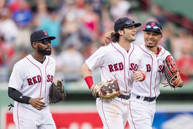 BOSTON, MA - SEPTEMBER 14: CJackie Bradley Jr. #19, Andrew Benintendi #16, and Mookie Betts #50 of the Boston Red Sox celebrate a victory against the Oakland Athletics on September 14, 2017 at Fenway Park in Boston, Massachusetts. (Photo by Billie Weiss/Boston Red Sox/Getty Images)