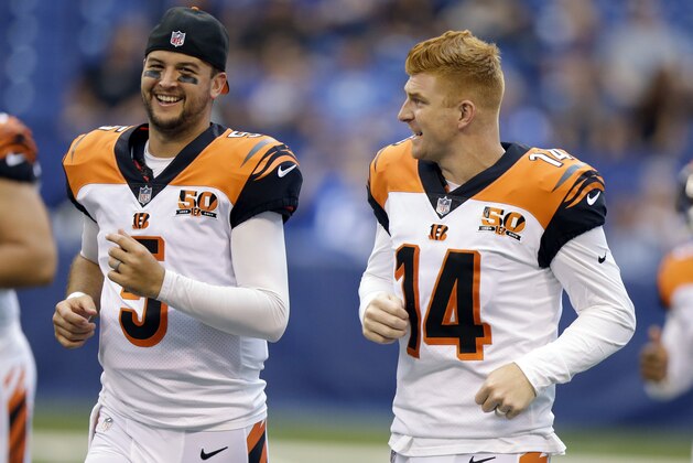 Cincinnati Bengals quarterback AJ McCarron, left, and quarterback Andy Dalton talk before a preseason NFL football game against the Indianapolis Colts in Indianapolis, Thursday, Aug. 31, 2017. (AP Photo/Michael Conroy)