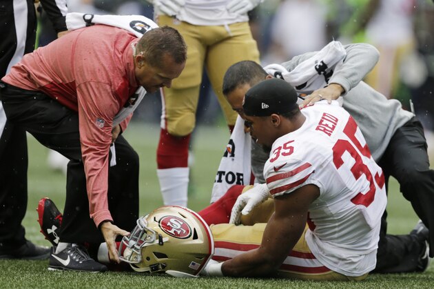 San Francisco 49ers strong safety Eric Reid (35) is tended to on the field after an injury in the first half of an NFL football game against the Seattle Seahawks, Sunday, Sept. 17, 2017, in Seattle. (AP Photo/John Froschauer)