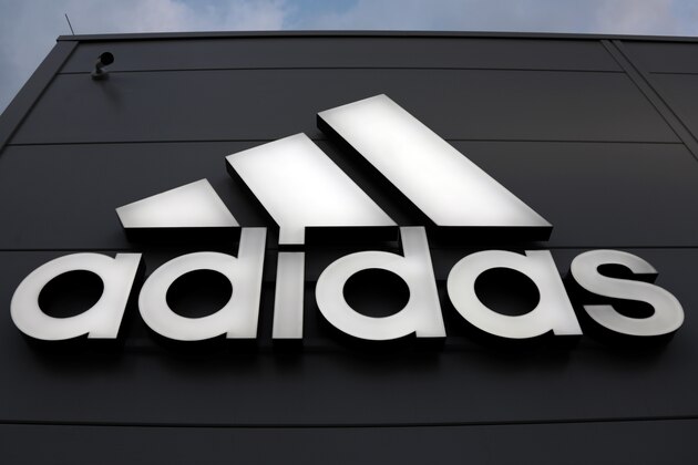 The logo of German sports equipment company adidas AG is illuminated at a factory outlet in Herzogenaurach, Germany, Tuesday, March 7, 2017. (AP Photo/Matthias Schrader)