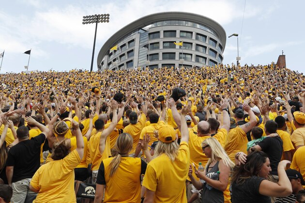 Iowa fans wave to children in the University of Iowa Stead Family Children's Hospital at the end of the first quarter of an NCAA college football game against North Texas, Saturday, Sept. 16, 2017, in Iowa City, Iowa. (AP Photo/Charlie Neibergall)