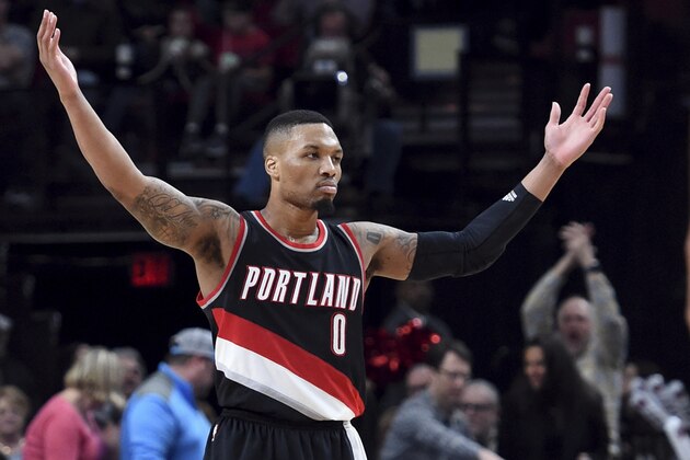 Portland Trail Blazers guard Damian Lillard acknowledges the crowd during the second half of the team's NBA basketball game against the Utah Jazz in Portland, Ore., Saturday, April 8, 2017. Lillard scored a franchise-record 59 points as the Blazers won 101-86. (AP Photo/Steve Dykes)