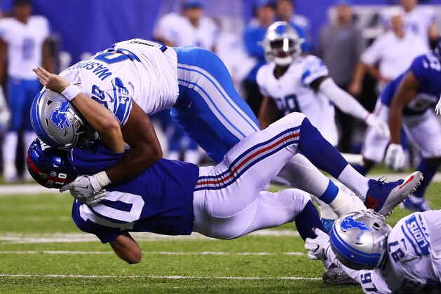 EAST RUTHERFORD, NJ - SEPTEMBER 18: Eli Manning #10 of the New York Giants is tackled by Cornelius Washington #90 of the Detroit Lions after an attempted pass in the fourth Quarter during their game at MetLife Stadium on September 18, 2017 in East Rutherford, New Jersey.  (Photo by Al Bello/Getty Images)