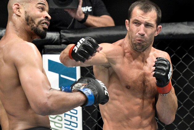 PITTSBURGH, PA - SEPTEMBER 16:  (R-L) Luke Rockhold punches David Branch in their middleweight bout during the UFC Fight Night event inside the PPG Paints Arena on September 16, 2017 in Pittsburgh, Pennsylvania. (Photo by Brandon Magnus/Zuffa LLC/Zuffa LLC via Getty Images)
