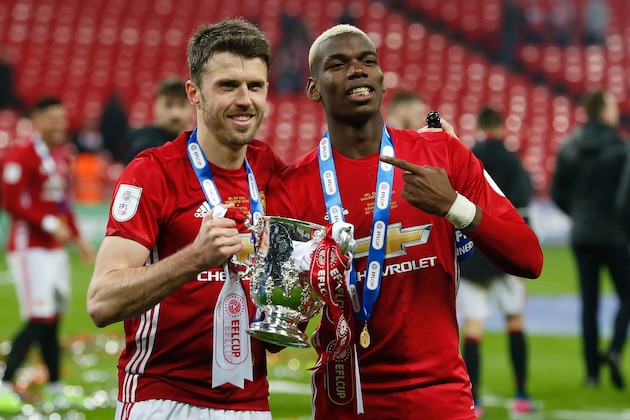 Manchester United's French midfielder Paul Pogba (R) and Manchester United's English midfielder Michael Carrick (L) celebrate with the trophy on the pitch after their victory in the English League Cup final football match between Manchester United and Southampton at Wembley stadium in north London on February 26, 2017.
Zlatan Ibrahimovic sealed the first major silverware of Jose Mourinho's Manchester United reign and broke Southampton's hearts as the Swedish star's late goal clinched a dramatic 3-2 victory in Sunday's League Cup final. / AFP PHOTO / Ian KINGTON / RESTRICTED TO EDITORIAL USE. No use with unauthorized audio, video, data, fixture lists, club/league logos or 'live' services. Online in-match use limited to 75 images, no video emulation. No use in betting, games or single club/league/player publications.  /         (Photo credit should read IAN KINGTON/AFP/Getty Images)