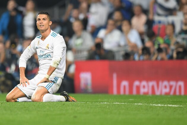 Real Madrid's forward from Portugal Cristiano Ronaldo kneels on the field during the Spanish league football match Real Madrid CF against Real Betis  at the Santiago Bernabeu stadium in Madrid on September 20, 2017. / AFP PHOTO / GABRIEL BOUYS        (Photo credit should read GABRIEL BOUYS/AFP/Getty Images)