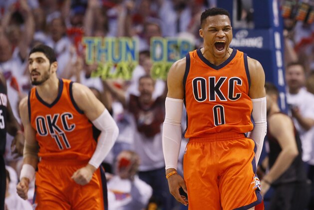 Oklahoma City Thunder guard Russell Westbrook (0) shouts following a dunk by teammate Enes Kanter (11) in the first half of Game 4 of a first-round NBA basketball playoff series in Oklahoma City, Sunday, April 23, 2017. (AP Photo/Sue Ogrocki)