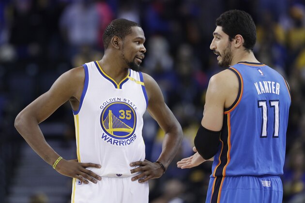 Golden State Warriors' Kevin Durant (35) talks to Oklahoma City Thunder's Enes Kanter (11) during the first half of an NBA basketball game Wednesday, Jan. 18, 2017, in Oakland, Calif. (AP Photo/Marcio Jose Sanchez)