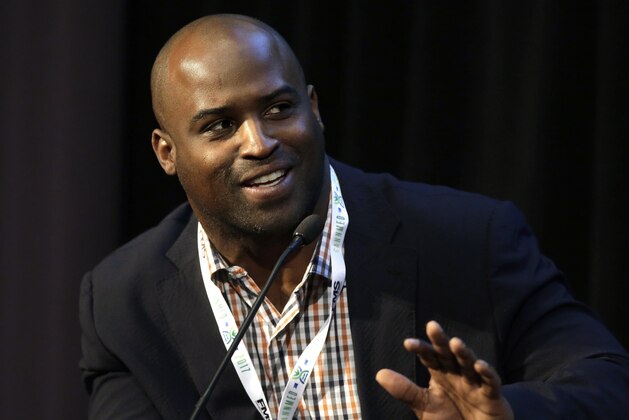 Former NFL football player Ricky Williams, who played for the New Orleans Saints and the Miami Dolphins among other teams, addresses an audience during a conference on medical marijuana at Harvard Medical School, Tuesday, April 11, 2017, in Boston. (AP Photo/Steven Senne)