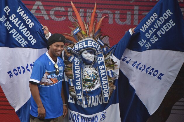 TOPSHOT - Brazilian player Ronaldinho poses with the Salvadoran character known as the Indio Cuscatleco, at the National Stadium Jorge 'Mágico' Gonzalez in San Salvador, on August 8, 2017. 
Ronaldinho met with some 500 children and young people living in areas plagued by the violence affecting El Salvador and who are part of the Police Athletic League prevention program, driven by the national Civil Police.  / AFP PHOTO / Marvin RECINOS        (Photo credit should read MARVIN RECINOS/AFP/Getty Images)