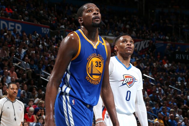 OKLAHOMA CITY, OK - FEBRUARY 11: Russell Westbrook #0 of the Oklahoma City Thunder and Kevin Durant #35 of the Golden State Warriors looks on during the game on February 11, 2017 at Chesapeake Energy Arena in Oklahoma City, Oklahoma. NOTE TO USER: User expressly acknowledges and agrees that, by downloading and or using this photograph, User is consenting to the terms and conditions of the Getty Images License Agreement. Mandatory Copyright Notice: Copyright 2017 NBAE (Photo by Layne Murdoch/NBAE via Getty Images)