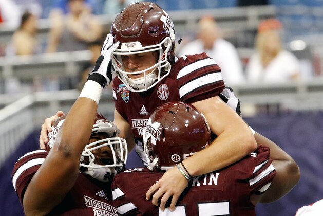 ST. PETERSBURG, FL - DECEMBER 26: Quarterback Nick Fitzgerald #7 of the Mississippi State Bulldogs celebrates with teammates after scoring a touchdown in the second quarter against the Miami (Oh) Redhawks in the St. Petersburg Bowl at Tropicana Field on December 26, 2016, in St. Petersburg, Florida. (Photo by Joseph Garnett, Jr. /Getty Images)