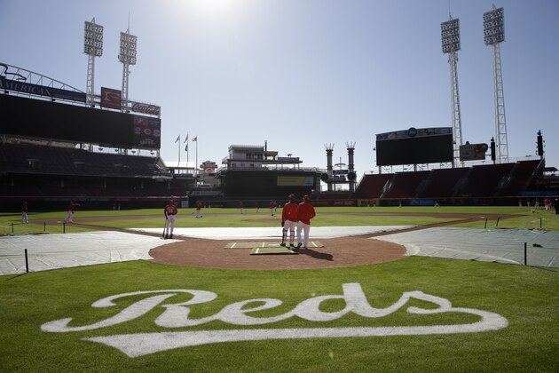 The Cincinnati Reds stand on the field during practice at Great American Ballpark, Sunday, April 3, 2016, in Cincinnati. (AP Photo/John Minchillo)