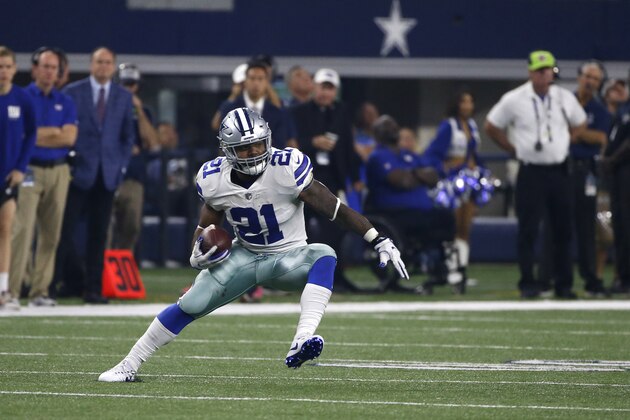 Dallas Cowboys running back Ezekiel Elliott (21) carries the ball for extra yardage against the New York Giants in the second half of an NFL football game, Sunday, Sept. 10, 2017, in Arlington, Texas. (AP Photo/Ron Jenkins)