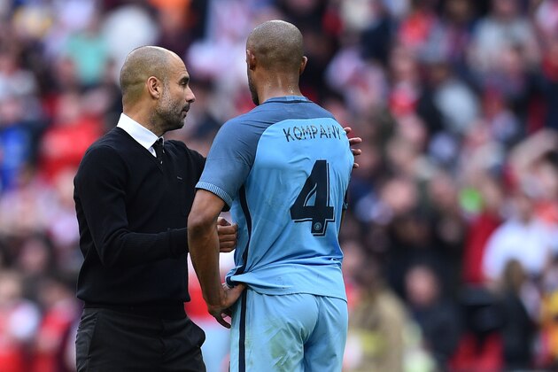 Manchester City's Spanish manager Pep Guardiola (L) consoles Manchester City's Belgian defender Vincent Kompany after the FA Cup semi-final football match between Arsenal and Manchester City at Wembley stadium in London on April 23, 2017. / AFP PHOTO / Glyn KIRK / NOT FOR MARKETING OR ADVERTISING USE / RESTRICTED TO EDITORIAL USE
        (Photo credit should read GLYN KIRK/AFP/Getty Images)