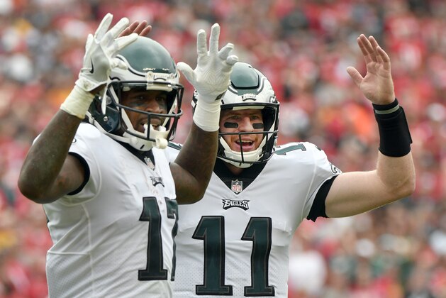 Philadelphia Eagles wide receiver Alshon Jeffery (17) and quarterback Carson Wentz (11) give the touchdown sign after Jeffery scored a touchdown during the second half of an NFL football game against the Kansas City Chiefs in Kansas City, Mo., Sunday, Sept. 17, 2017. (AP Photo/Ed Zurga)