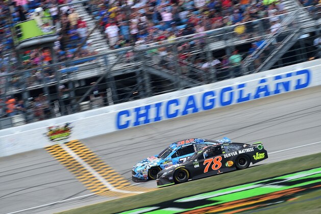 JOLIET, IL - SEPTEMBER 17:  Martin Truex Jr., driver of the #78 Furniture Row/Denver Mattress Toyota, takes the checkered flag to win the Monster Energy NASCAR Cup Series Tales of the Turtles 400 at Chicagoland Speedway on September 17, 2017 in Joliet, Illinois.  (Photo by Jared C. Tilton/Getty Images)