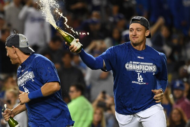 Sep 22, 2017; Los Angeles, CA, USA;  Los Angeles Dodgers players Trayce Thompson (right) and Austin Barnes celebrate with champagne after defeating the San Francisco Giants at Dodger Stadium. The Dodgers win the National League west title. Mandatory Credit: Richard Mackson-USA TODAY Sports