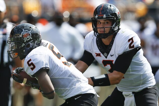 Oklahoma State quarterback Mason Rudolph (2) hands off to running back Justice Hill (5) in the second quarter of an NCAA football game against Pittsburgh, Saturday, Sept. 16, 2017, in Pittsburgh. (AP Photo/Keith Srakocic)