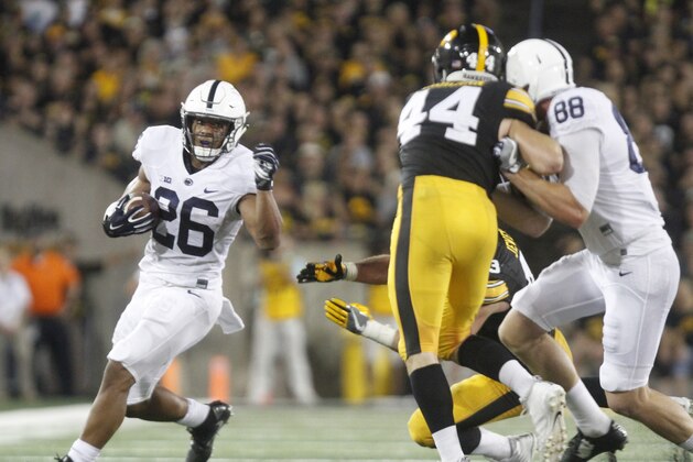 IOWA CITY, IOWA- SEPTEMBER 23:  Running back Saquon Barkley #26 of the Penn State Nittany Lions rushes up field during the second quarter past linebackers Josey Jewell #43 and Ben Niemann #44 of the Iowa Hawkeyes on September 23, 2017 at Kinnick Stadium in Iowa City, Iowa.  (Photo by Matthew Holst/Getty Images)