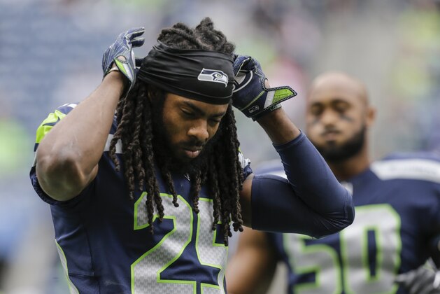 SEATTLE, WA - SEPTEMBER 17: Cornerback Richard Sherman #25 of the Seattle Seahawks adjusts his head band during warm ups before a game against the San Francisco 49ers at CenturyLink Field on September 17, 2017 in Seattle, Washington. The Seahawks won the game 12-9. (Photo by Stephen Brashear/Getty Images)