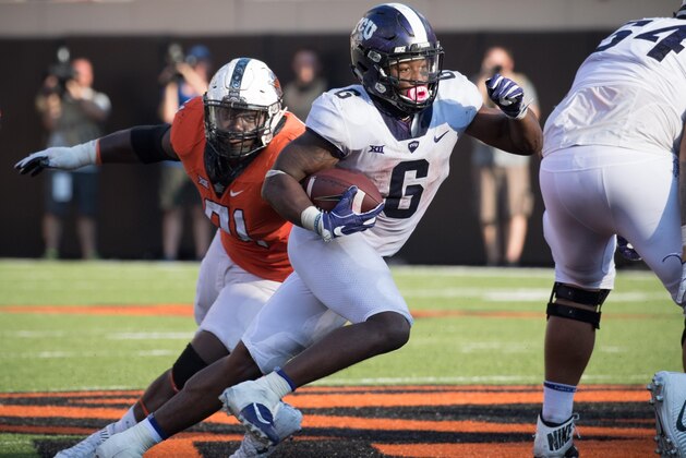 Sep 23, 2017; Stillwater, OK, USA; TCU Horned Frogs running back Darius Anderson (6) runs the ball past Oklahoma State Cowboys defensive tackle DeQuinton Osborne (91) during the second half at Boone Pickens Stadium. Mandatory Credit: Rob Ferguson-USA TODAY Sports