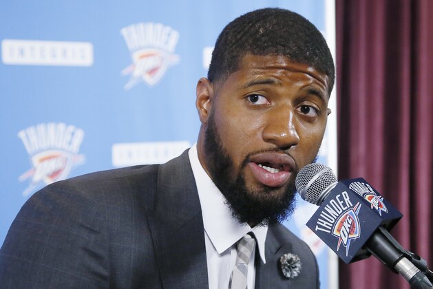 FILE - In this July 12, 2017, file photo, Oklahoma City Thunder forward Paul George answers a question at his first news conference since Oklahoma City's blockbuster trade with the Indiana Pacers, in Oklahoma City. George travels back to Indiana on Dec. 13, 2017, for the first time since the Pacers surprisingly dealt him to Oklahoma City. (AP Photo/Sue Ogrocki, File)