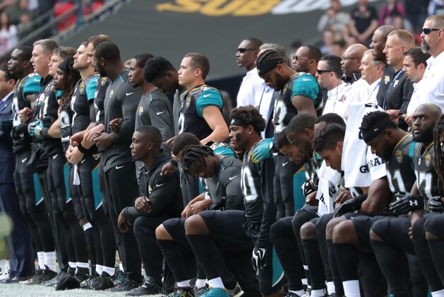 LONDON, ENGLAND - SEPTEMBER 24: Jacksonville Jaguars players kneel during the playing of the national anthem against the Baltimore Ravens at Wembley Stadium on September 24, 2017 in London, United Kingdom. (Photo by Mitchell Gunn/Getty Images)
