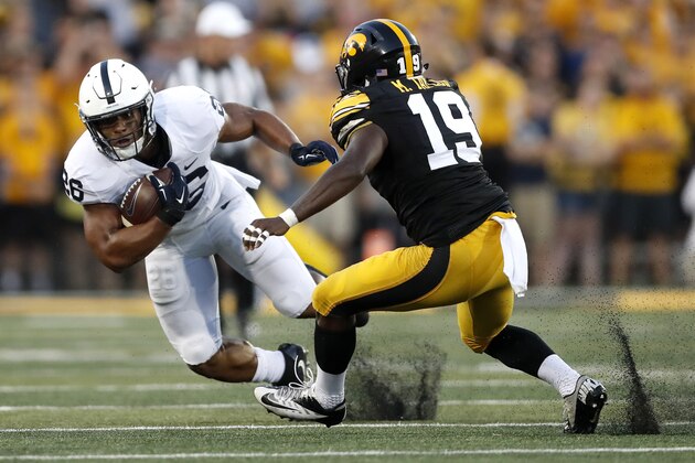 Penn State running back Saquon Barkley, left, runs with the ball as Iowa defensive back Miles Taylor defends during the first half of an NCAA college football game Saturday, Sept. 23, 2017, in Iowa City, Iowa. (AP Photo/Jeff Roberson)