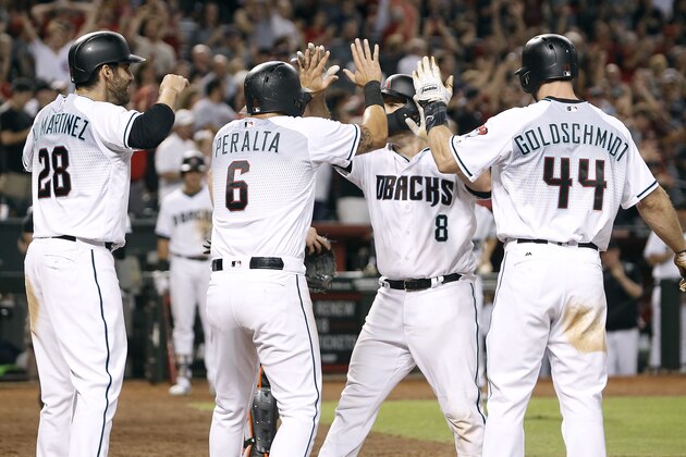 Arizona Diamondbacks' Chris Iannetta (8) is congratulated by teammates J.D. Martinez (28), David Peralta (6) and Paul Goldschmidt (44) after hitting a grand slam against the Miami Marlins during the sixth inning of a baseball game, Friday, Sept. 22, 2017, in Phoenix. It was Iannetta's second home run of the game. (AP Photo/Ralph Freso)