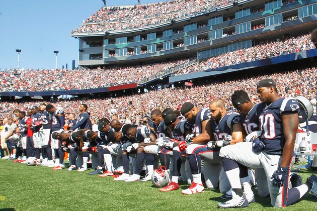 FOXBORO, MA - SEPTEMBER 24:  Members of the New England Patriots kneel during the National Anthem before a game against the Houston Texans at Gillette Stadium on September 24, 2017 in Foxboro, Massachusetts.  (Photo by Jim Rogash/Getty Images)