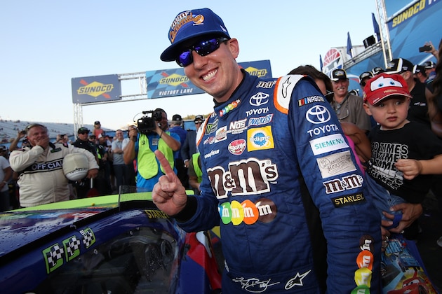 LOUDON, NH - SEPTEMBER 24:  Kyle Busch, driver of the #18 M&M's Caramel Toyota, celebrates in Victory Lane with the winner's sticker after winning the Monster Energy NASCAR Cup Series ISM Connect 300 at New Hampshire Motor Speedway on September 24, 2017 in Loudon, New Hampshire.  (Photo by Chris Graythen/Getty Images)