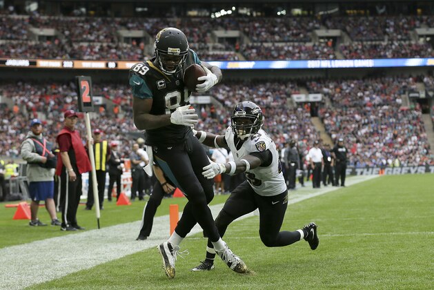 Jacksonville Jaguars tight end Marcedes Lewis (89) catches a touchdown against Baltimore Ravens strong safety Tony Jefferson during the second half of an NFL football game at Wembley Stadium in London, Sunday Sept. 24, 2017. (AP Photo/Tim Ireland)