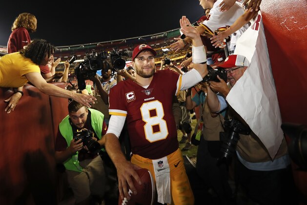 Washington Redskins quarterback Kirk Cousins (8) is greeted by fans as he leave the field after an NFL football game against the Oakland Raiders in Landover, Md., Sunday, Sept. 24, 2017. The Redskins defeated the Raiders 27-10. (AP Photo/Alex Brandon)