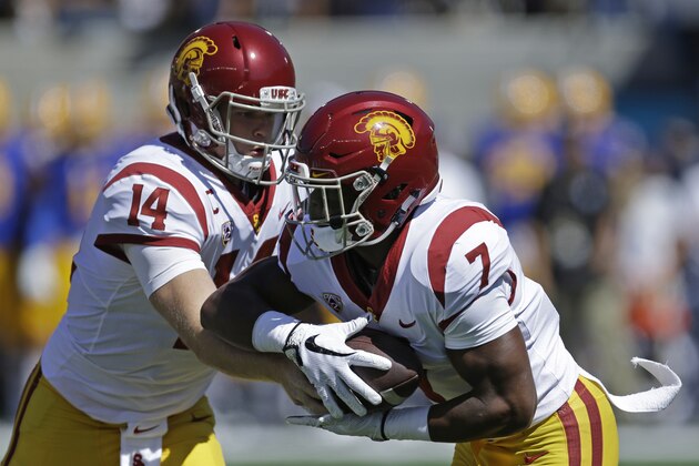 Southern California quarterback Sam Darnold, left, hands off to Stephen Carr (7) California's during the first half of an NCAA college football game Saturday, Sept. 23, 2017, in Berkeley, Calif. (AP Photo/Ben Margot)