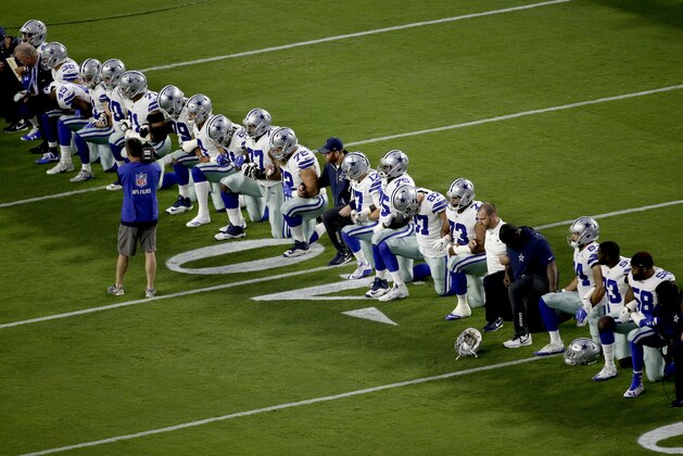 The Dallas Cowboys take a knee prior to the national anthem prior to an NFL football game against the Arizona Cardinals, Monday, Sept. 25, 2017, in Glendale, Ariz. (AP Photo/Matt York)
