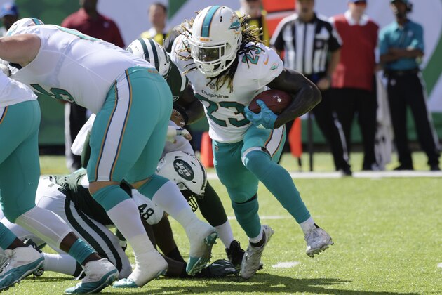 Miami Dolphins' Jay Ajayi (23) rushes during the first half of an NFL football game against the New York Jets Sunday, Sept. 24, 2017, in East Rutherford, N.J. (AP Photo/Bill Kostroun)