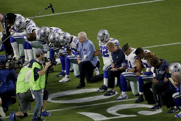 The Dallas Cowboys, led by owner Jerry Jones, center, take a knee prior to the national anthem prior to an NFL football game against the Arizona Cardinals, Monday, Sept. 25, 2017, in Glendale, Ariz. (AP Photo/Matt York)