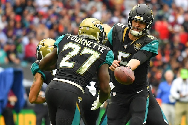 Sep 24, 2017; London, Middlesex, ENG;  Jacksonville Jaguars quarterback Blake Bortles (5) hands the ball off to Jacksonville Jaguars running back Leonard Fournette (27) during the second half of the game between the Baltimore ravens at the Jacksonville Jaguars at Wembley Stadium. Mandatory Credit: Steve Flynn-USA TODAY Sports