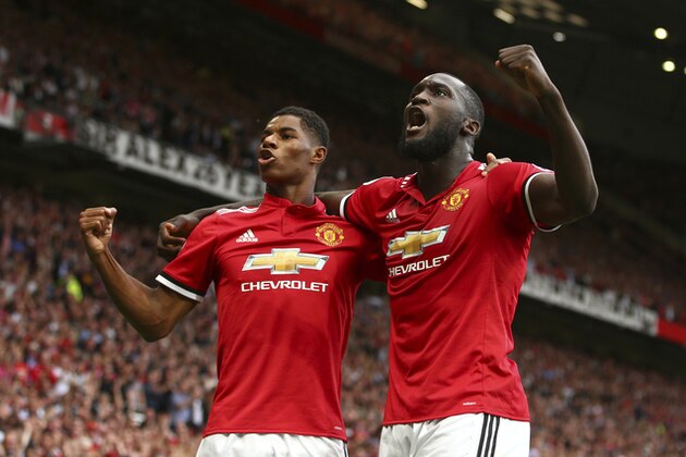 Manchester United's Romelu Lukaku, right, celebrates with Manchester United's Marcus Rashford after scoring his side's first goal of the game during the English Premier League soccer match between Manchester United and West Ham United at Old Trafford in Manchester, England, Sunday, Aug. 13, 2017. (AP Photo/Dave Thompson)