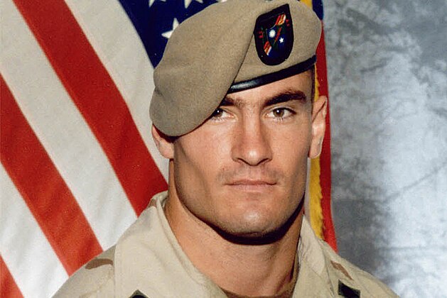 ** FILE ** Cpl. Pat Tillman is seen in a this 2003 file photo provided by Photography Plus. Just seven days after Pat Tillman's death, a top general warned there were strong indications that it was friendly fire and President Bush might embarrass himself if he said the NFL star-turned-soldier died in an ambush, according to a memo obtained by The Associated Press.  (AP Photo/Photography Plus via Williamson Stealth Media Solutions, FILE)