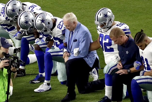 The Dallas Cowboys, led by owner Jerry Jones, center, take a knee prior to the national anthem prior to an NFL football game against the Arizona Cardinals, Monday, Sept. 25, 2017, in Glendale, Ariz. (AP Photo/Matt York)